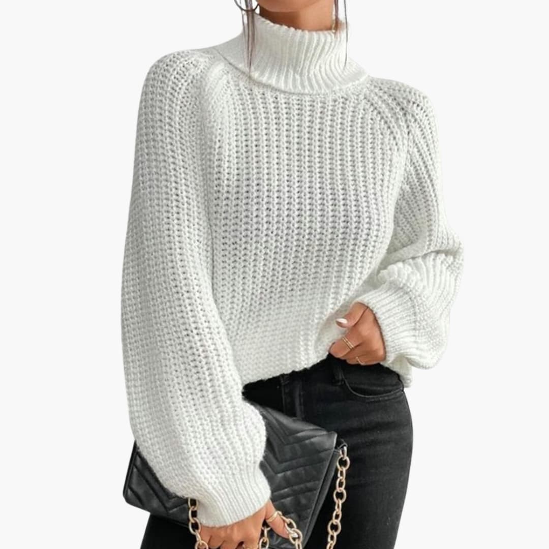 Women's loose cream turtleneck sweater with dropped shoulders and relaxed cozy fit