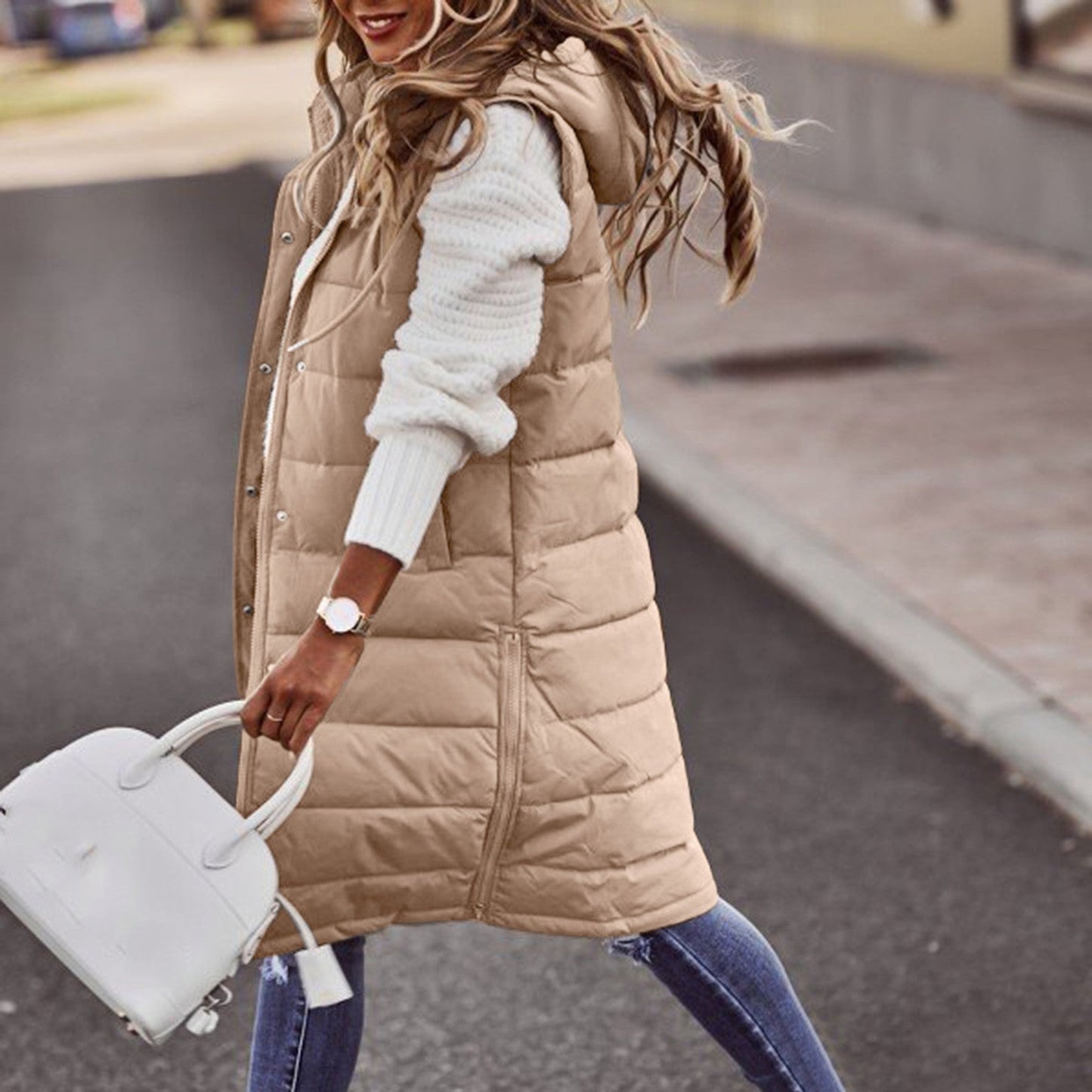 Women's long quilted down vest with hood, insulated winter outerwear for layering, sleek modern silhouette