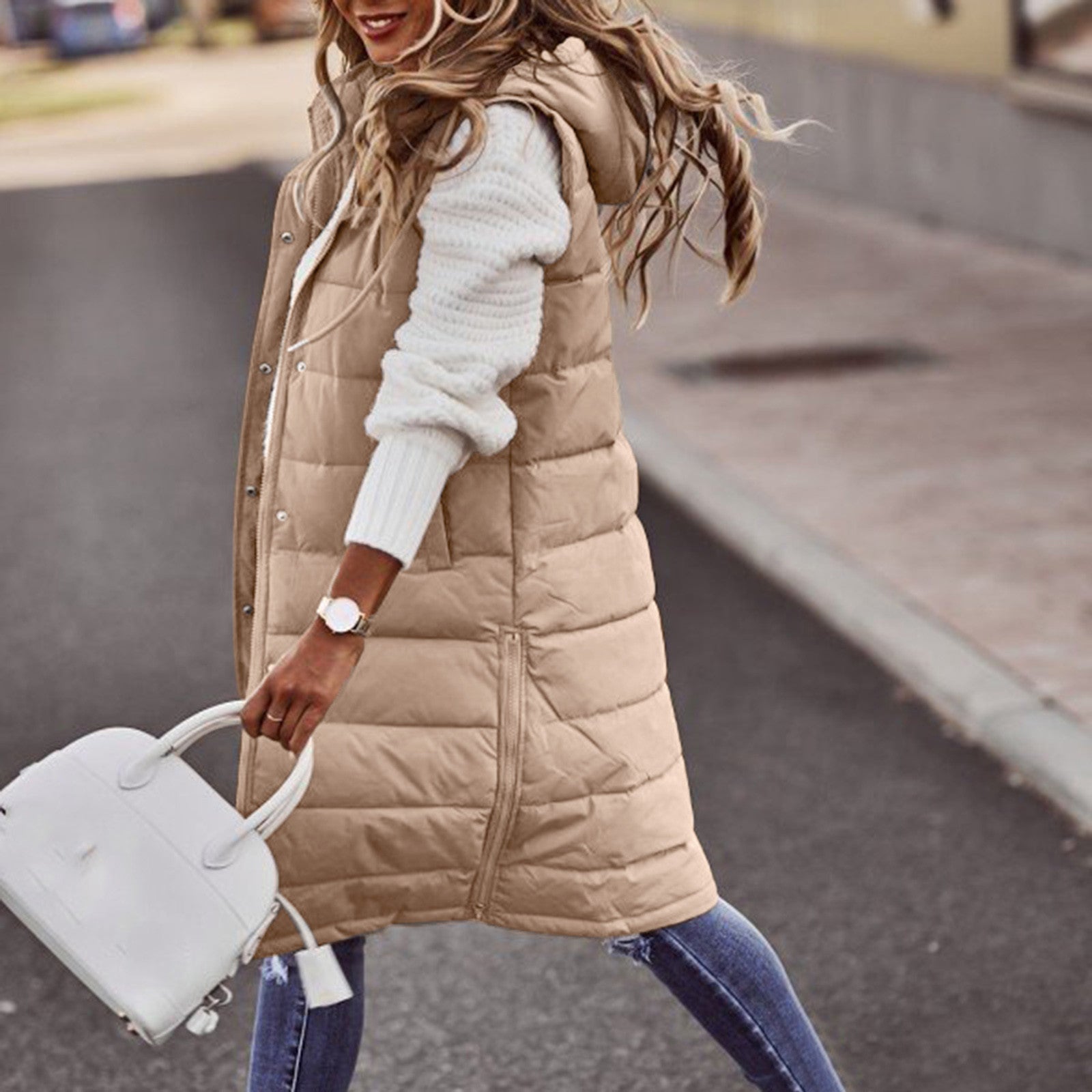 Women's long quilted down vest with hood, insulated winter outerwear for layering, sleek modern silhouette