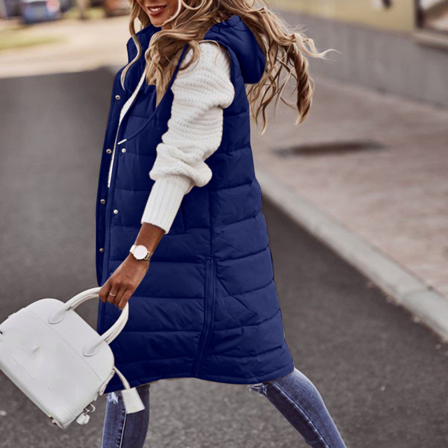 Women's long quilted down vest with hood, insulated winter outerwear for layered cold-weather styling