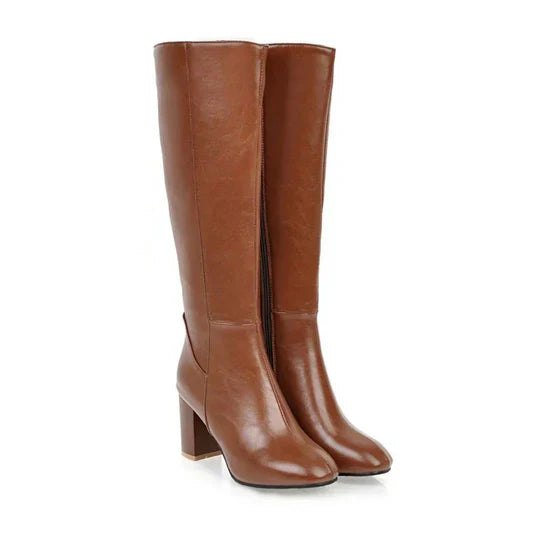 Black women's knee-high stiletto boots with sleek shaft, elegant silhouette for day-to-night style