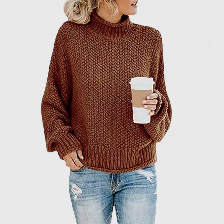 Women's chunky knit sweater in neutral tone, relaxed fit high neck cozy layering essential