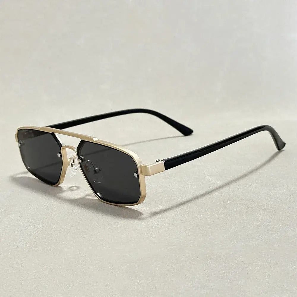 Geometric gold-tone gradient sunglasses with dark UV-defense lenses and sharp architectural angles
