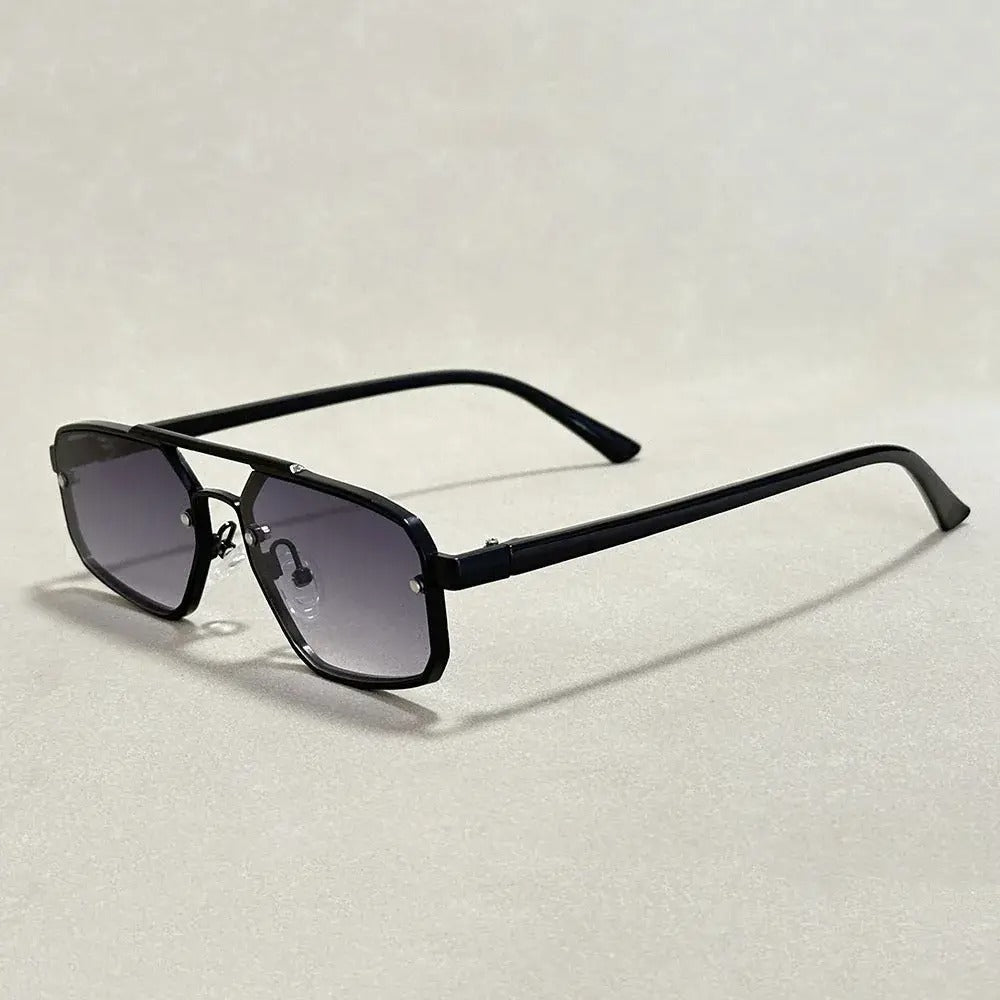 Geometric gold-tone gradient sunglasses with dark UV-protective lenses, minimalist architectural frame