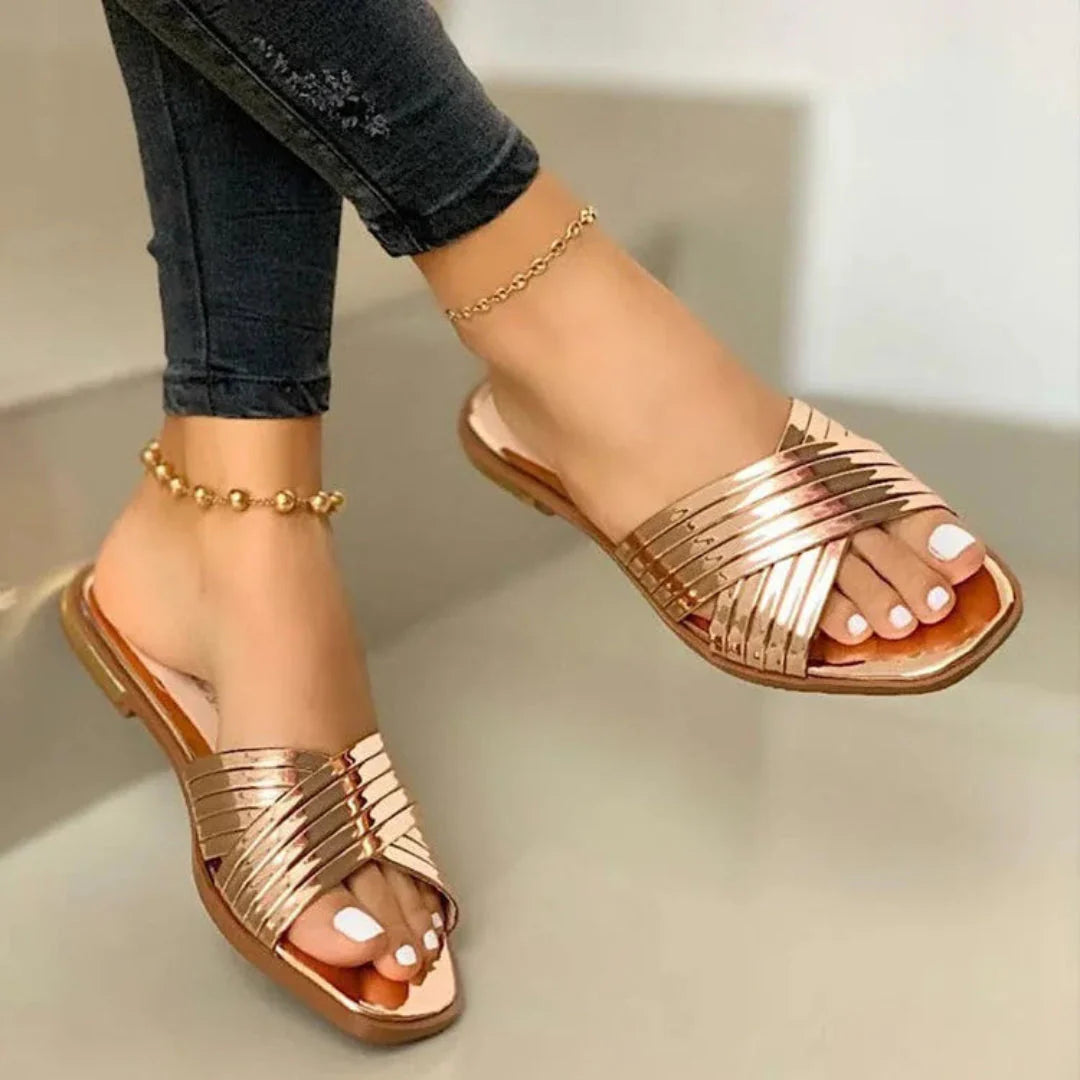 Women's glossy patent crisscross slip-on flat sandals with open-toe silhouette and polished straps