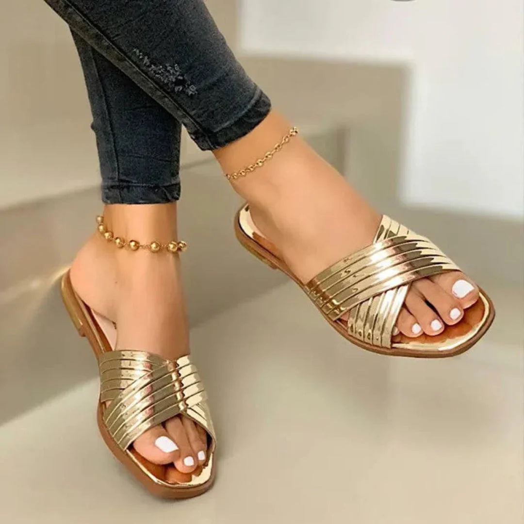 Women's glossy patent crisscross slip-on flat sandals with open-toe silhouette and polished straps