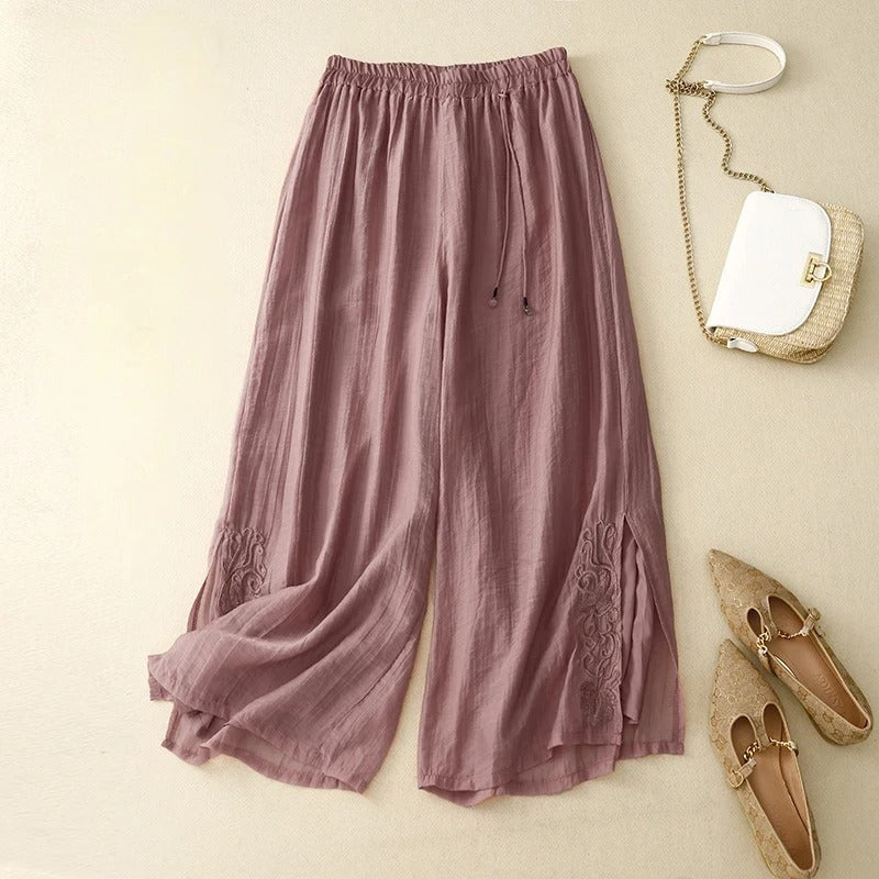 Women's wide-leg linen pants in neutral tone with delicate floral embroidery detail