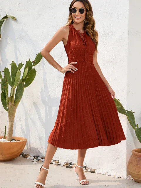 Black halter neck pleated midi dress with shoulder-baring silhouette and flowing pleat detailing