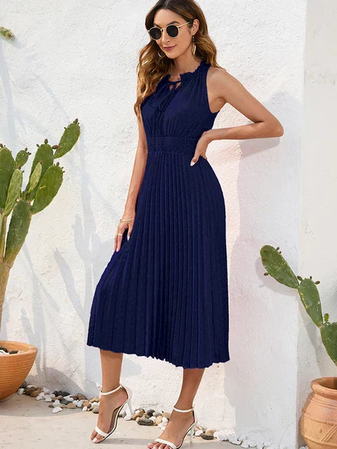 Black halter neck pleated midi dress with shoulder-baring silhouette and flowing pleat detailing
