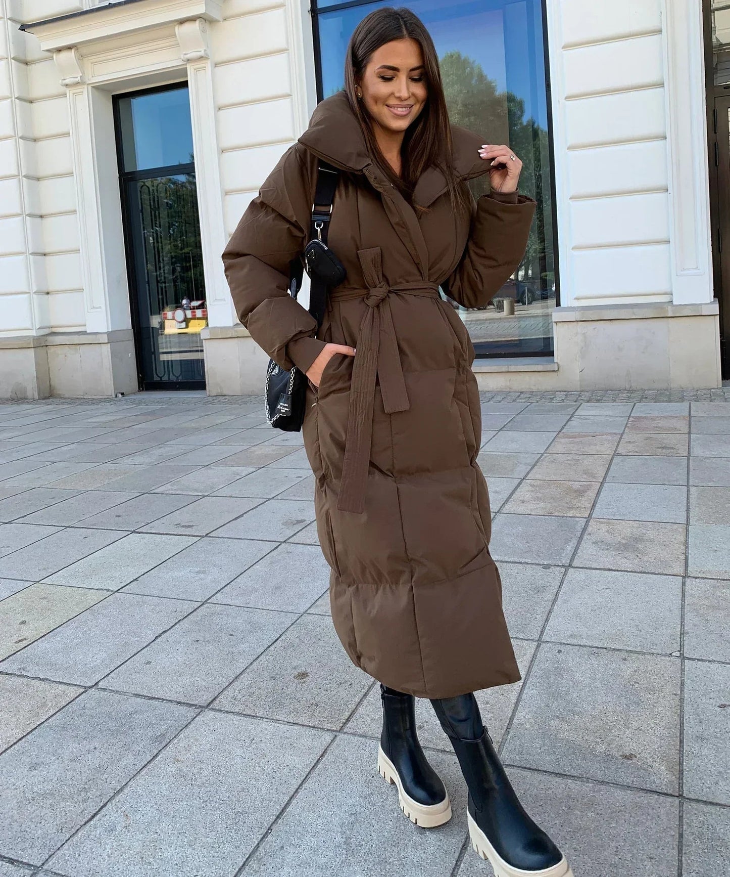 Women's long winter jacket in elegant silhouette, warm full-length coat with timeless classic style