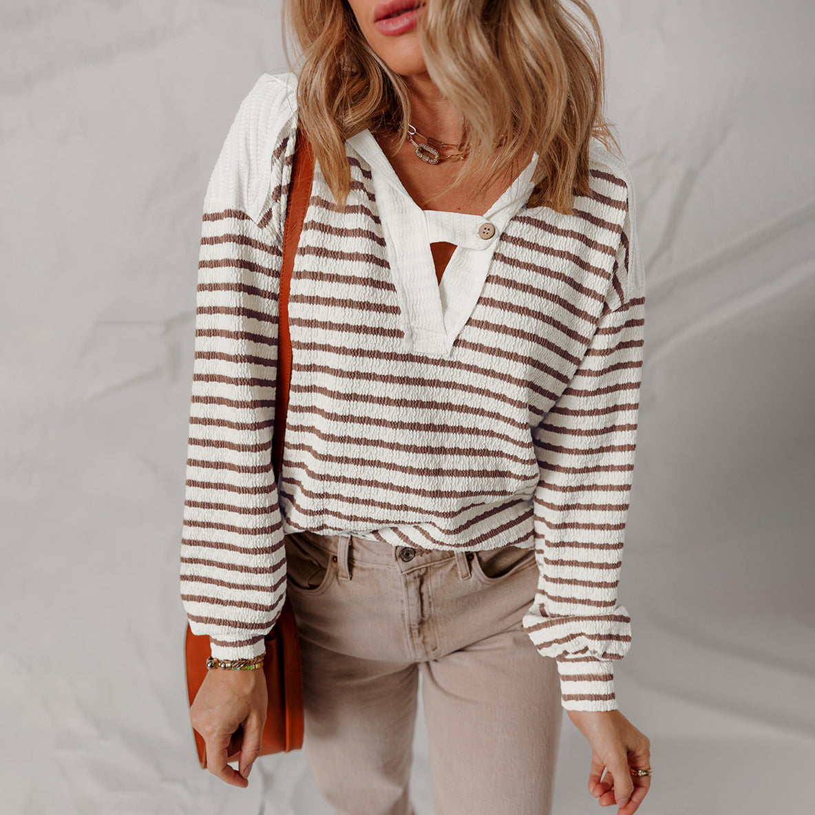 Women's striped knit sweater soft textured V-neck with buttoned strap accent in modern casual style