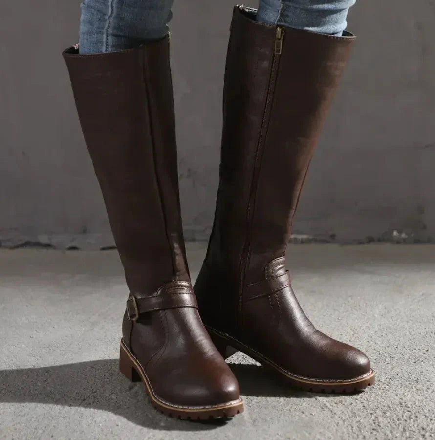 Women's black faux leather knee-high boots with low block heel and side buckle detail