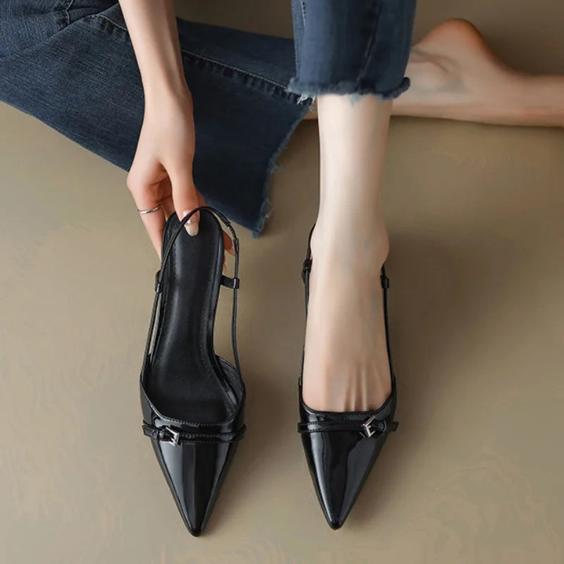 Women's black pointed toe kitten heels with mini buckle detail, sleek low heel for everyday elegance