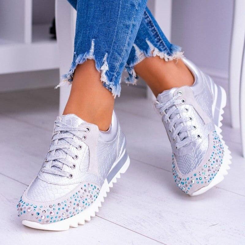 Women's white embossed synthetic leather fashion sneakers with lace-up closure and rhinestone toe accents