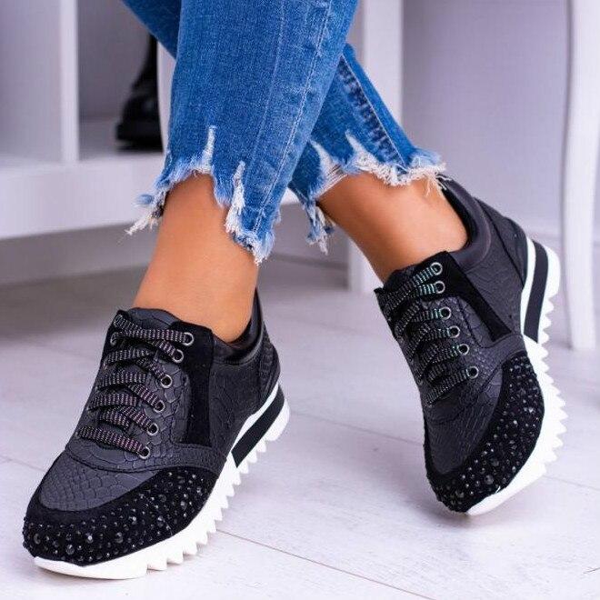 Women's white embossed synthetic leather fashion sneakers with lace-up closure and rhinestone toe accents