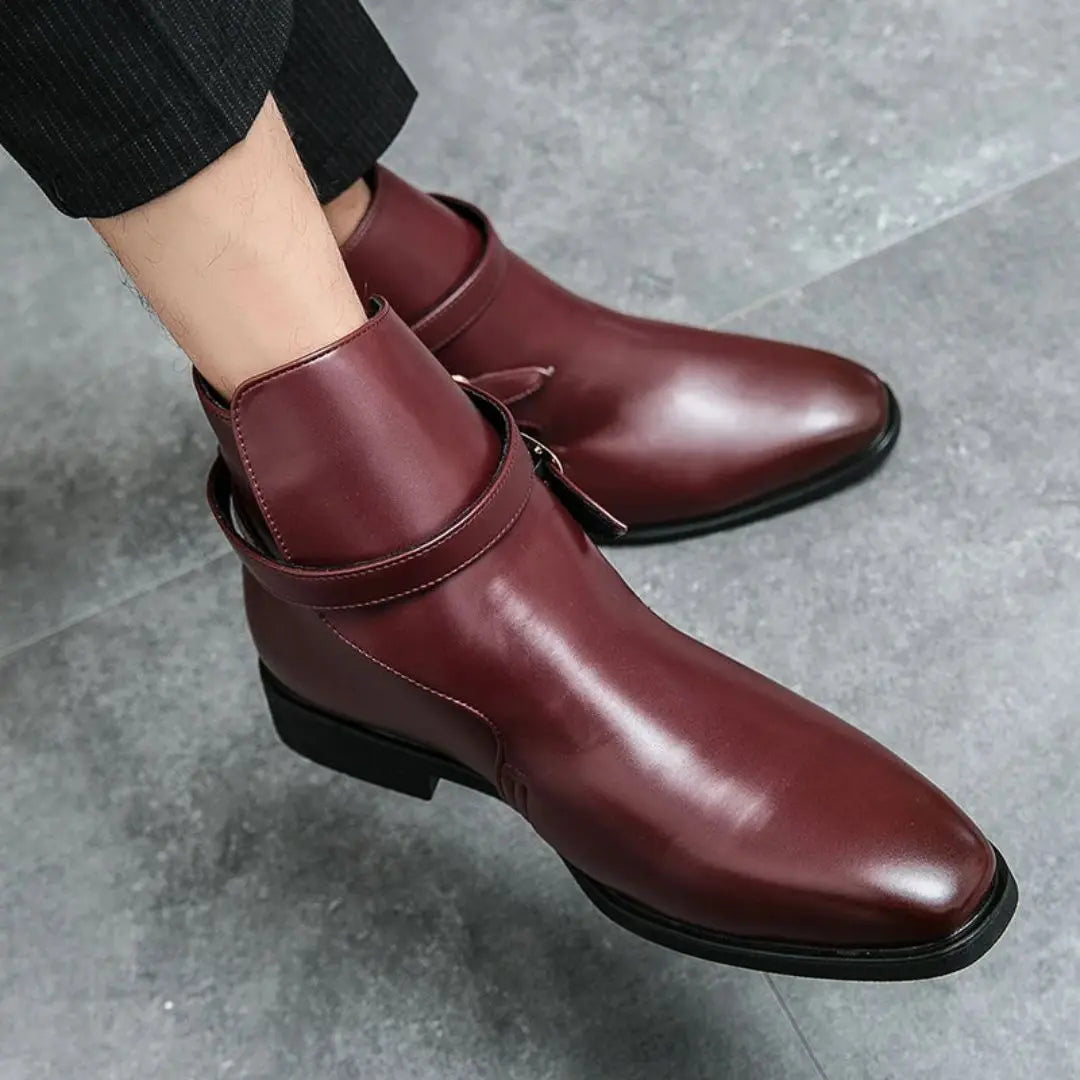 Men's black full-grain leather ankle boots with sleek strap closure and lightweight durable sole