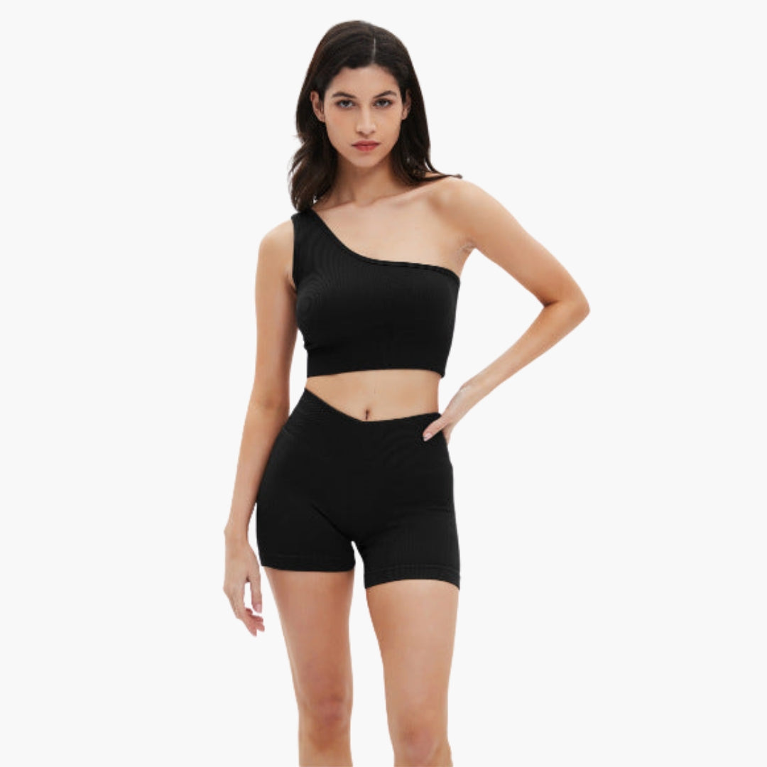 Women's ribbed asymmetrical one-shoulder crop top and high-waisted shorts set in sporty style