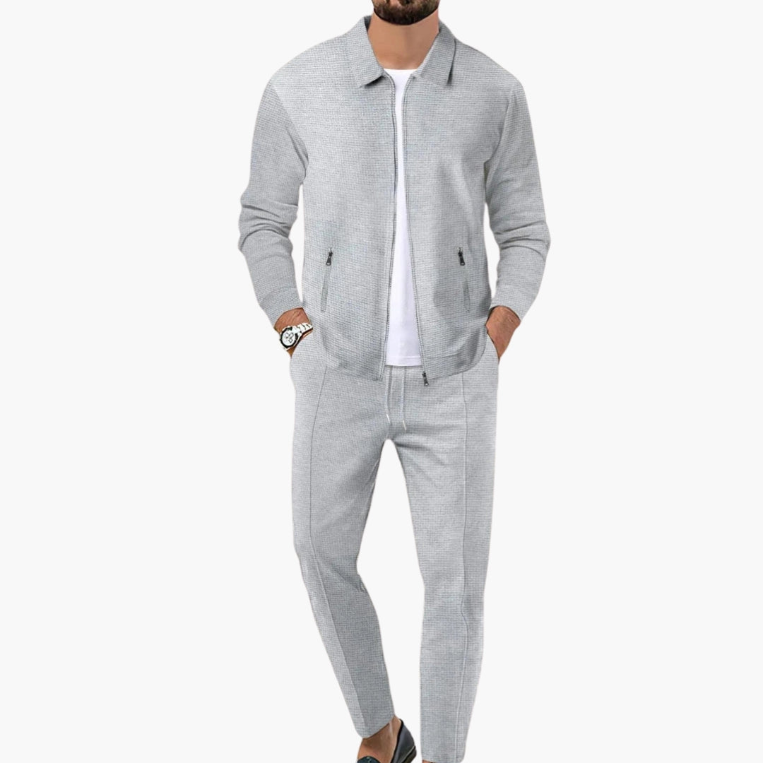 Men's gray zip-up tracksuit set with tapered pants, elastic waist, and pointed collar