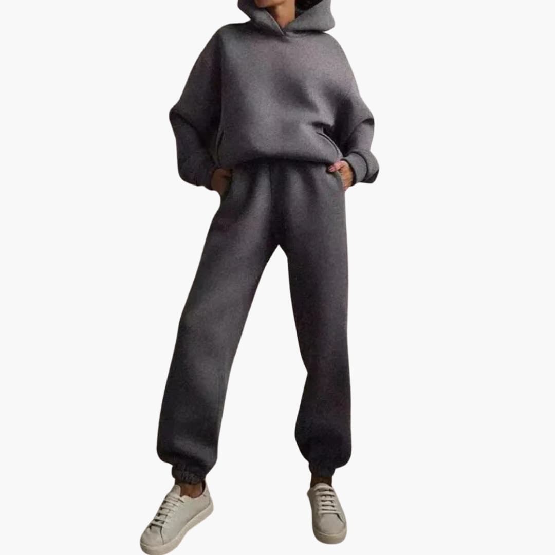 Women's grey hoodie jogger set with elastic waist, pockets, and fitted hooded silhouette
