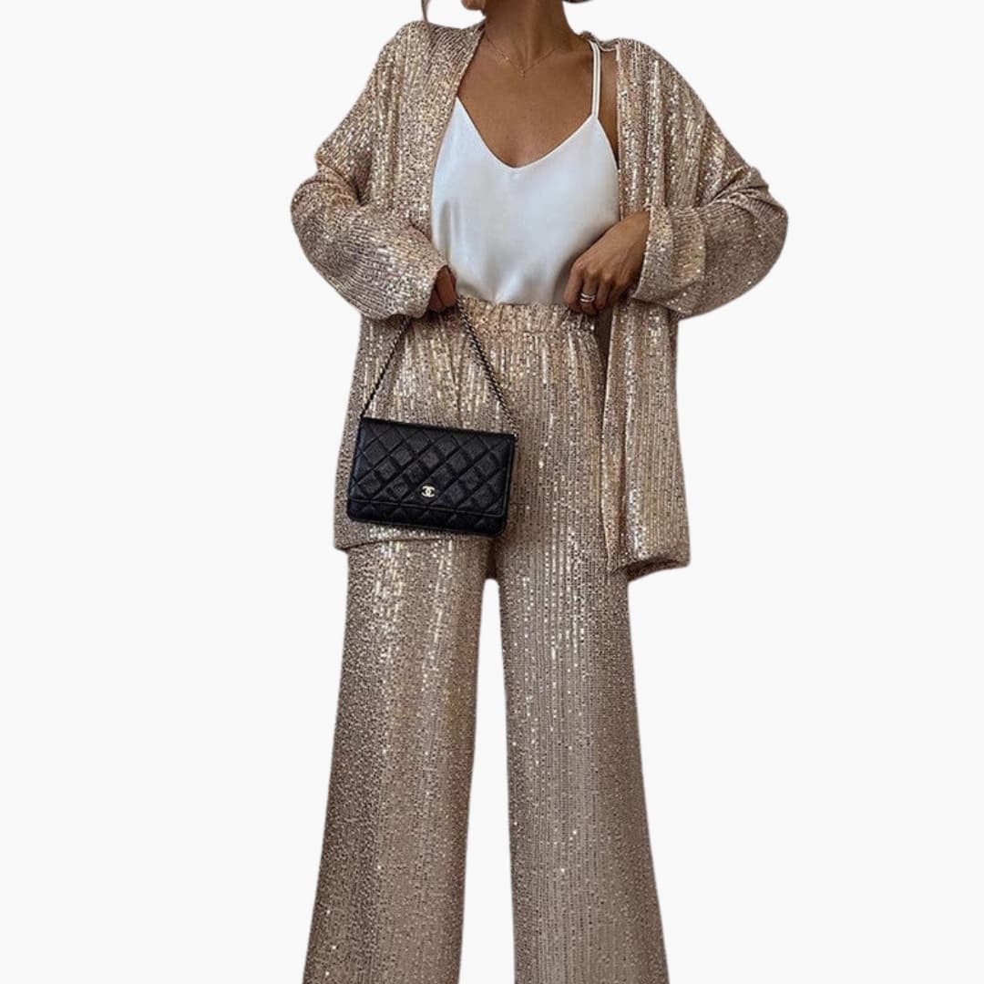 Women's silver sequin blazer set with wide-leg pants, structured waist, glamorous evening two-piece