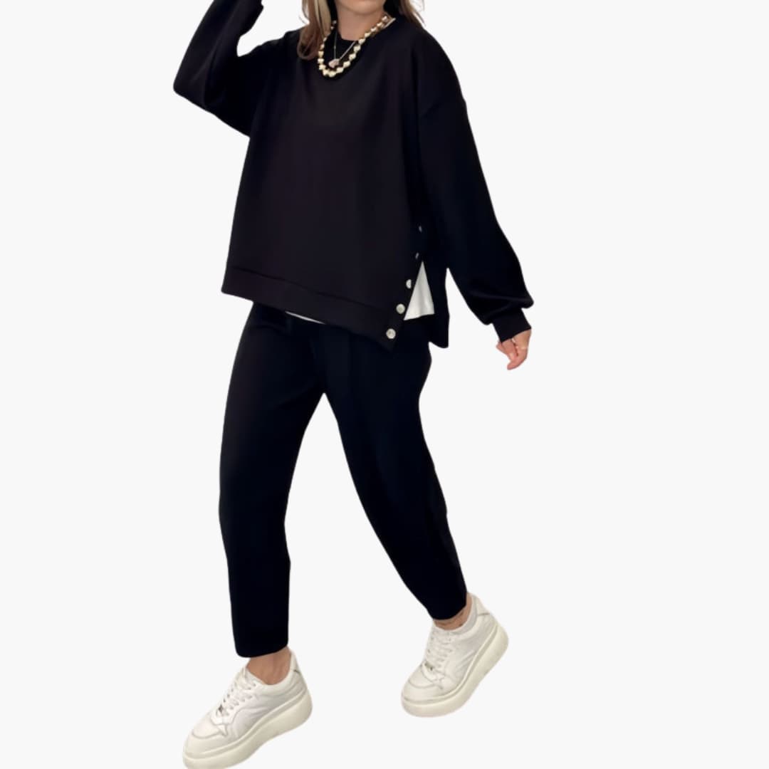 Women's two-piece loose fit sports set in neutral tones with decorative button details on short-sleeve top