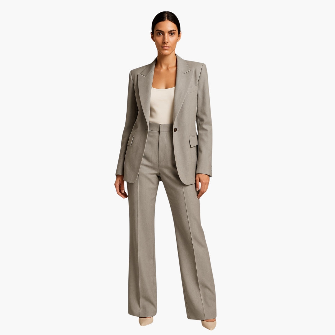Women's navy blue tailored suit set with structured notched lapel jacket and wide-leg pants