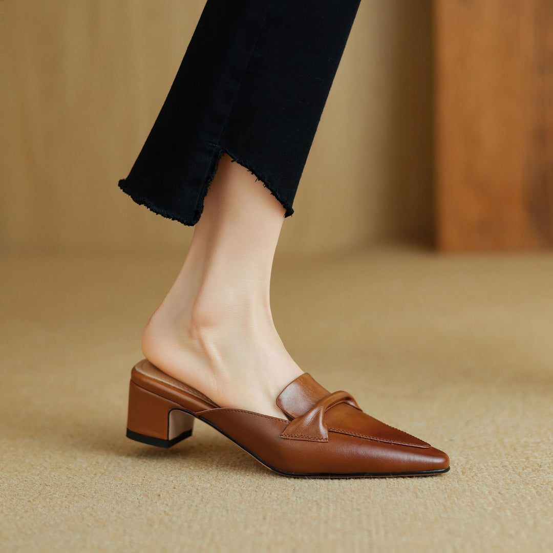 Women's tan leather slip-on mules with elegant bow-trim detail, premium breathable upper, desk-to-dinner style