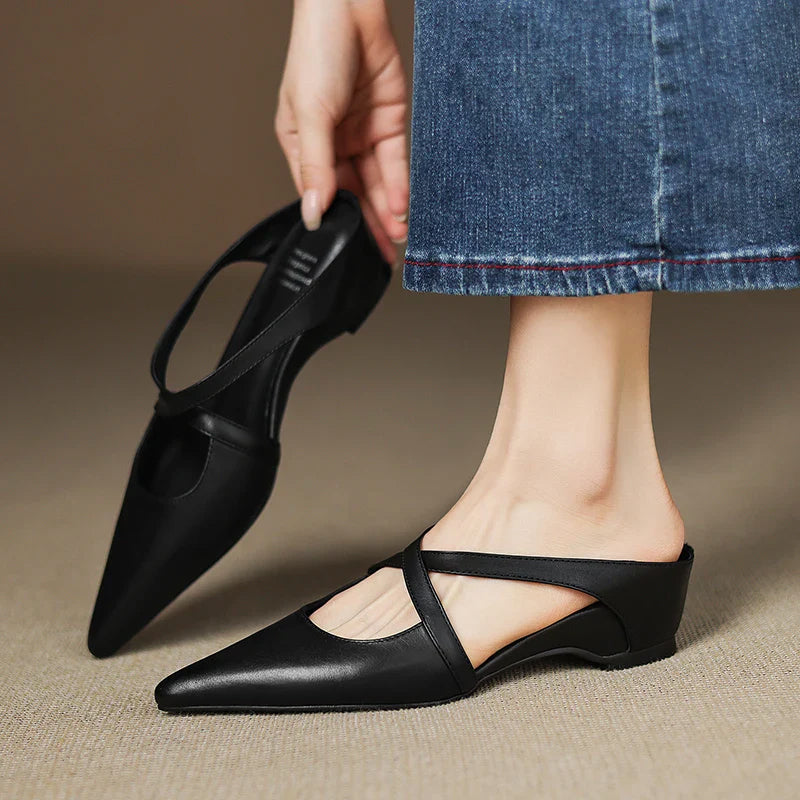 Women's faux leather pointed toe mule flats with criss-cross straps, sleek slip-on silhouette