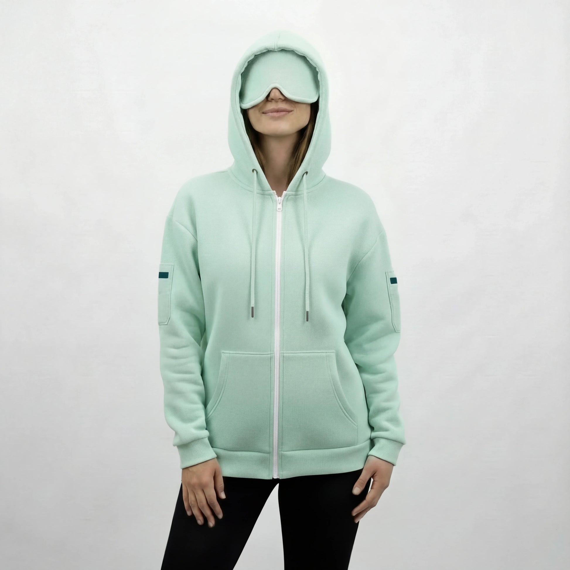 Gray travel hoodie with built-in eye mask hood, designed for frequent flyers seeking in-flight comfort
