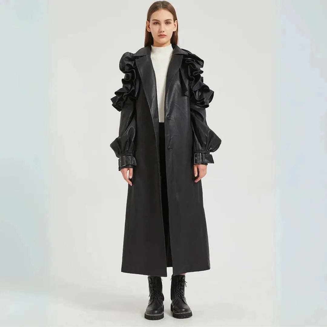 Black faux leather trench coat dramatic ruffled sleeves cinched belt long tailored silhouette