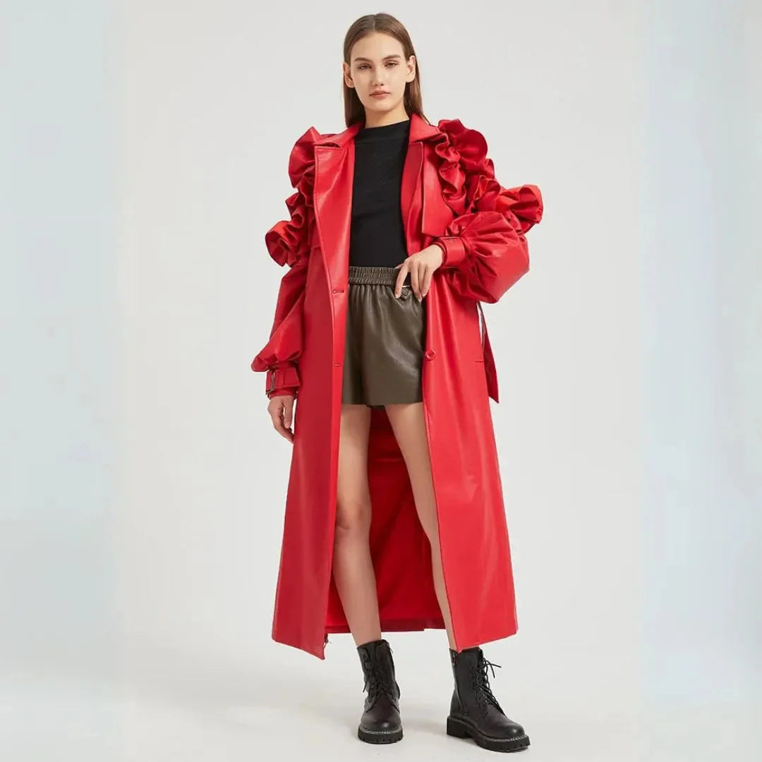 Black faux leather trench coat dramatic ruffled sleeves cinched belt long tailored silhouette