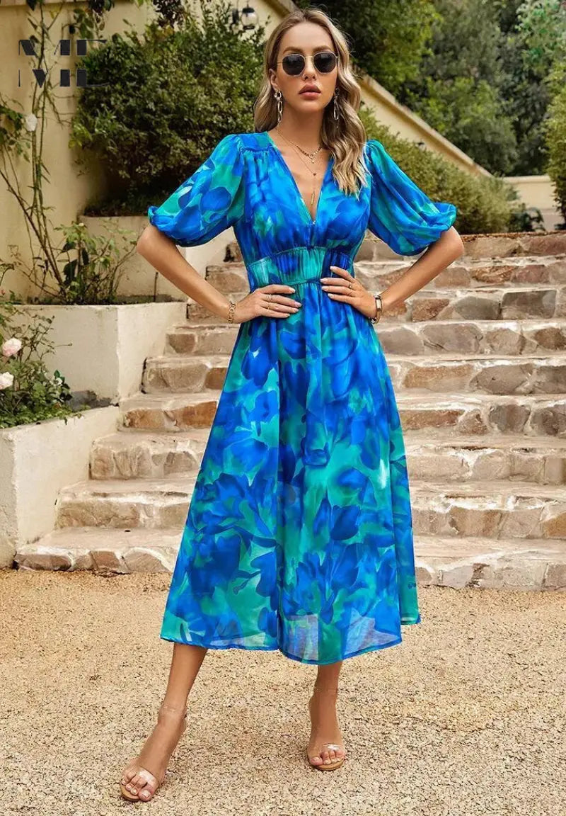 Women's floral midi dress with puff sleeves, flowing silhouette, vibrant print, timeless elegant style