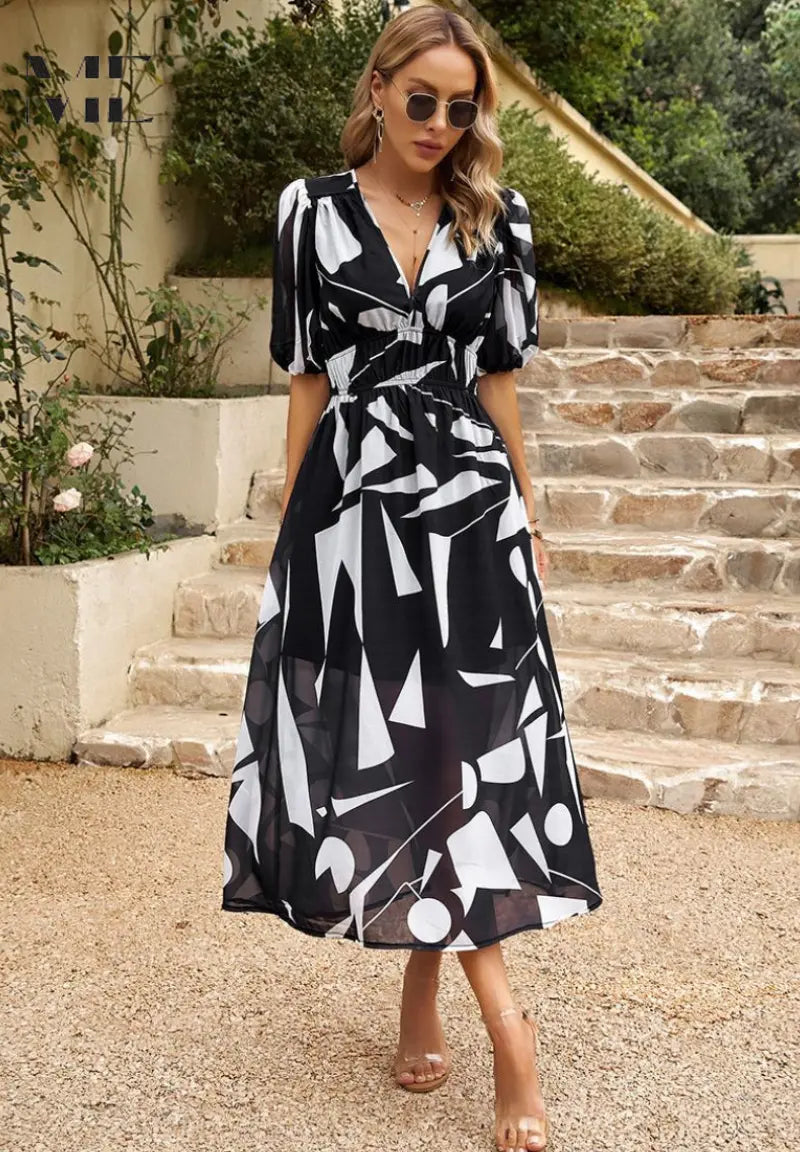 Women's floral midi dress with romantic puff sleeves, flowing silhouette, vibrant print elegant style
