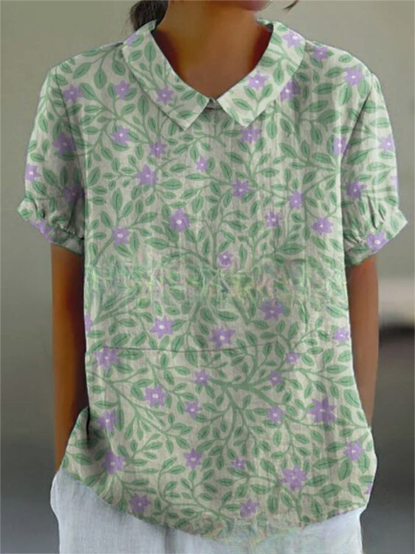 Women's white relaxed-fit collared blouse with short gathered sleeves and curved hem, office-ready