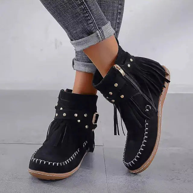 Women's black flat fringe boots with rivet detail and belt buckle edgy western style