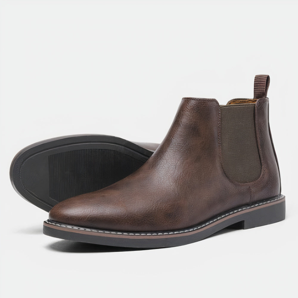 Men's black full-grain leather Chelsea boots with elastic side panels and sleek timeless silhouette