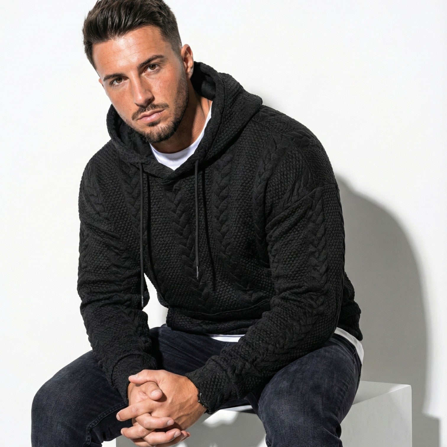 Men's oversized black knit hoodie with drawstring hood, relaxed urban streetwear silhouette