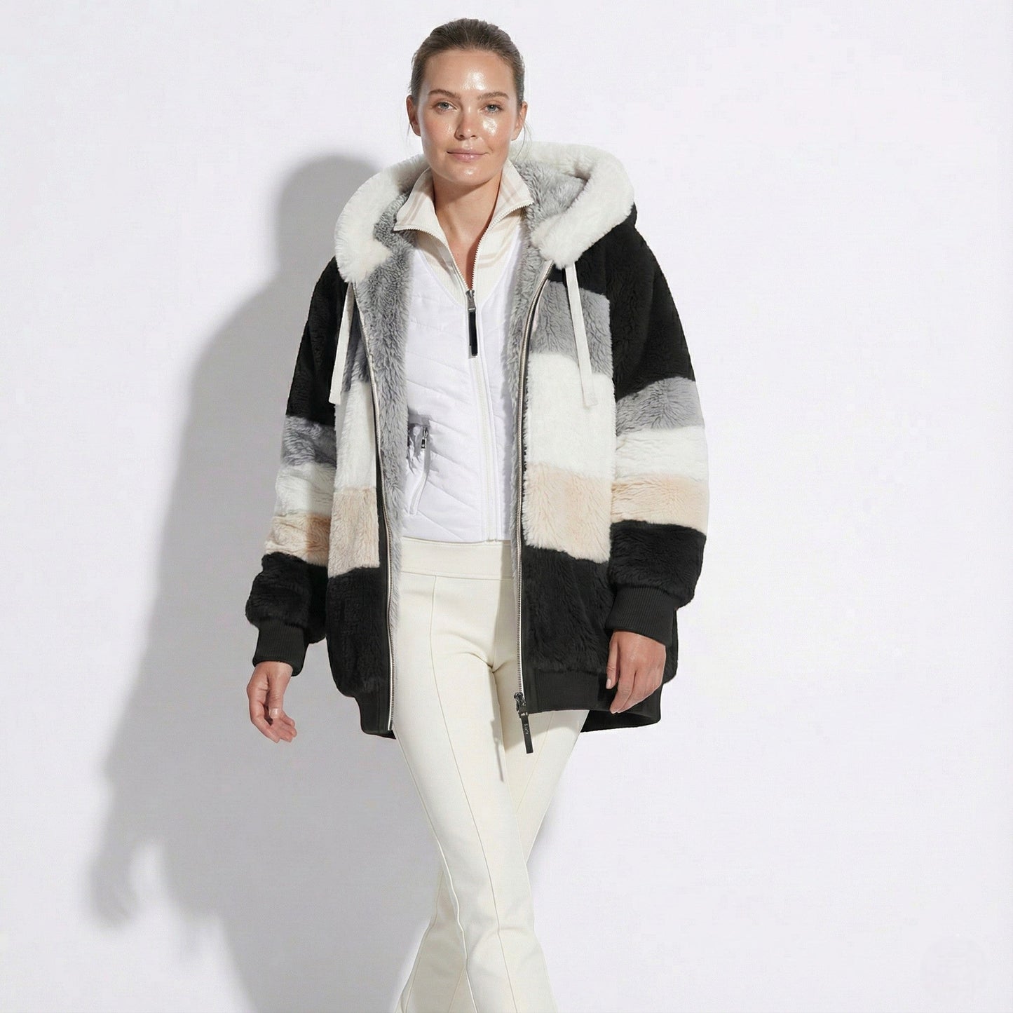 Women's oversized faux fur hooded jacket in cozy neutral tones with relaxed urban silhouette