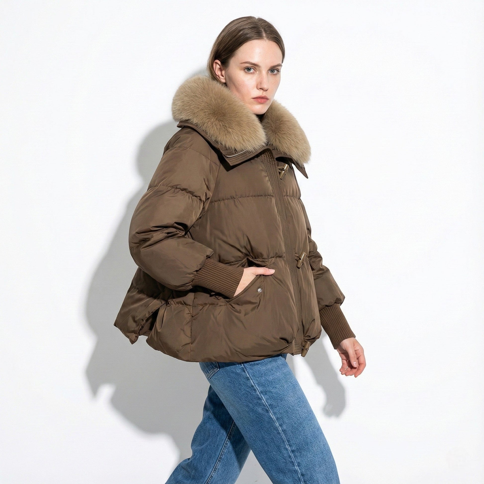 Women's oversized winter puffer jacket in neutral tone with plush fur collar for cozy warmth