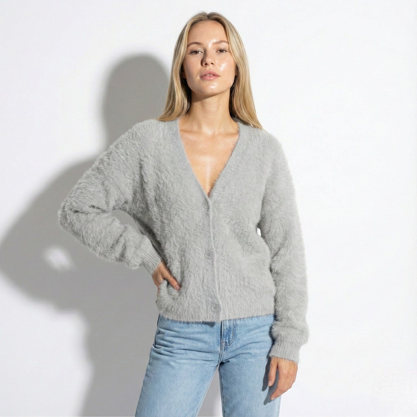 Women's oversized fuzzy knit cardigan in soft neutral tone with relaxed silhouette and elegant button front