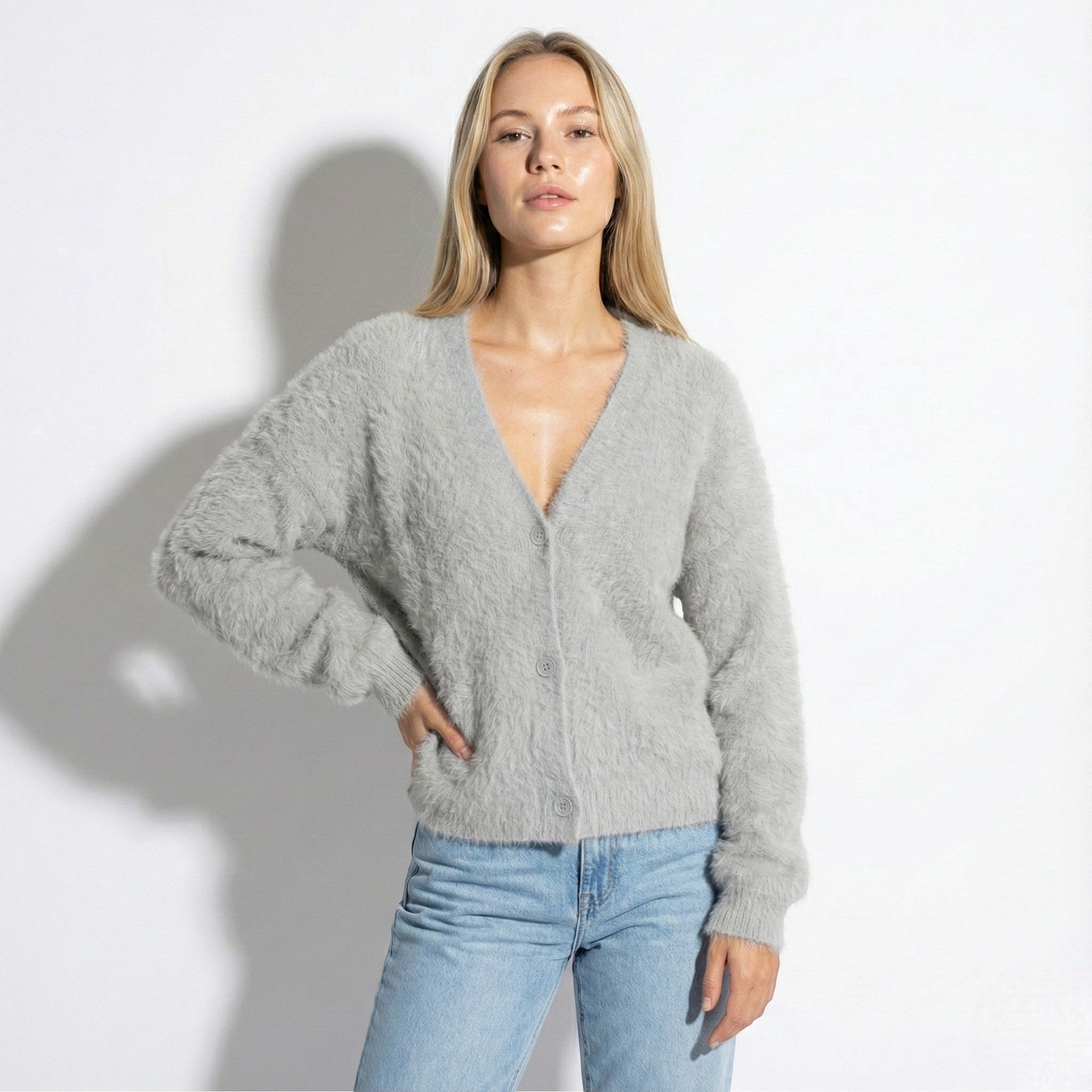 Women's oversized fuzzy knit cardigan in soft neutral tone with relaxed silhouette and elegant button front