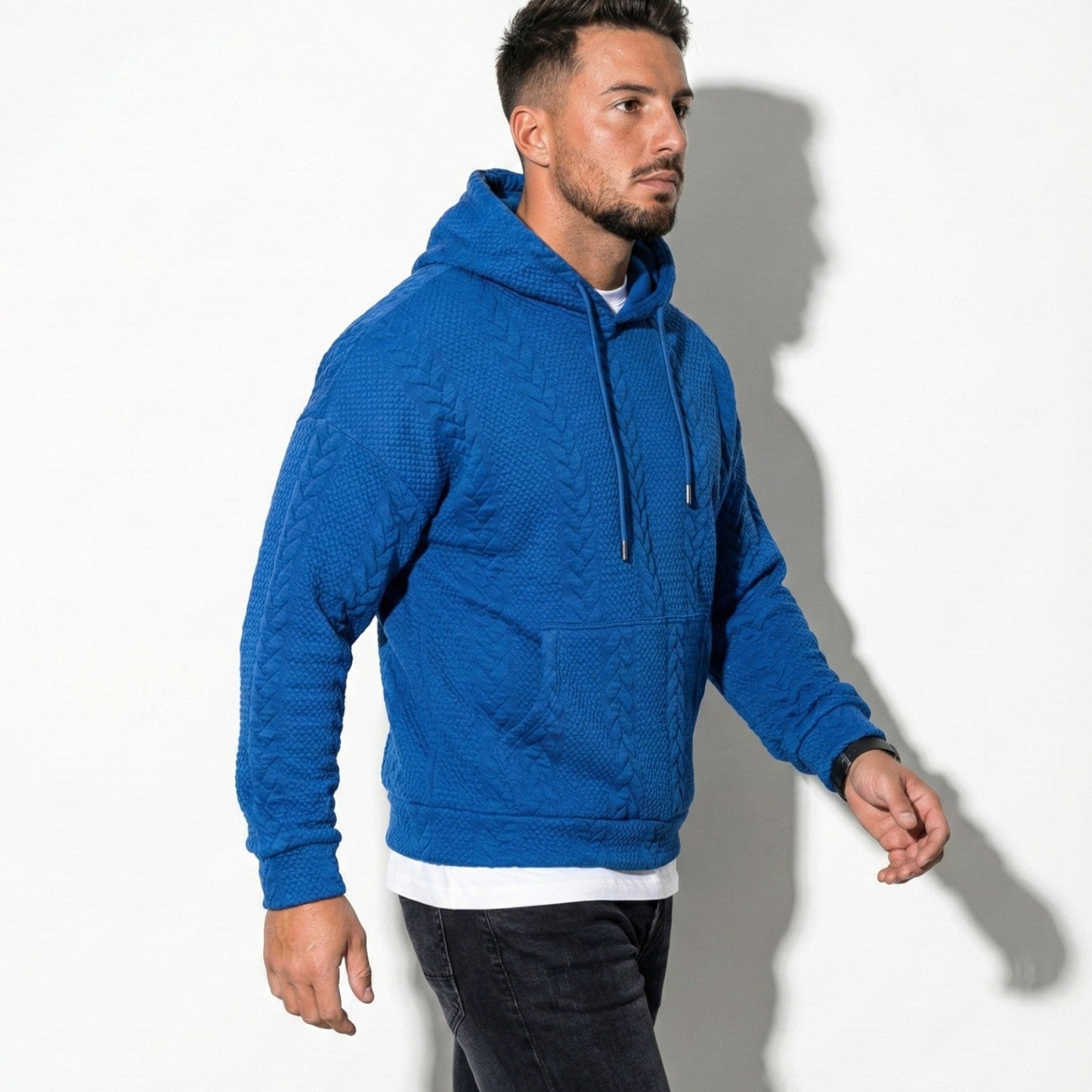 Men's oversized black knit hoodie with drawstring hood, relaxed urban streetwear silhouette