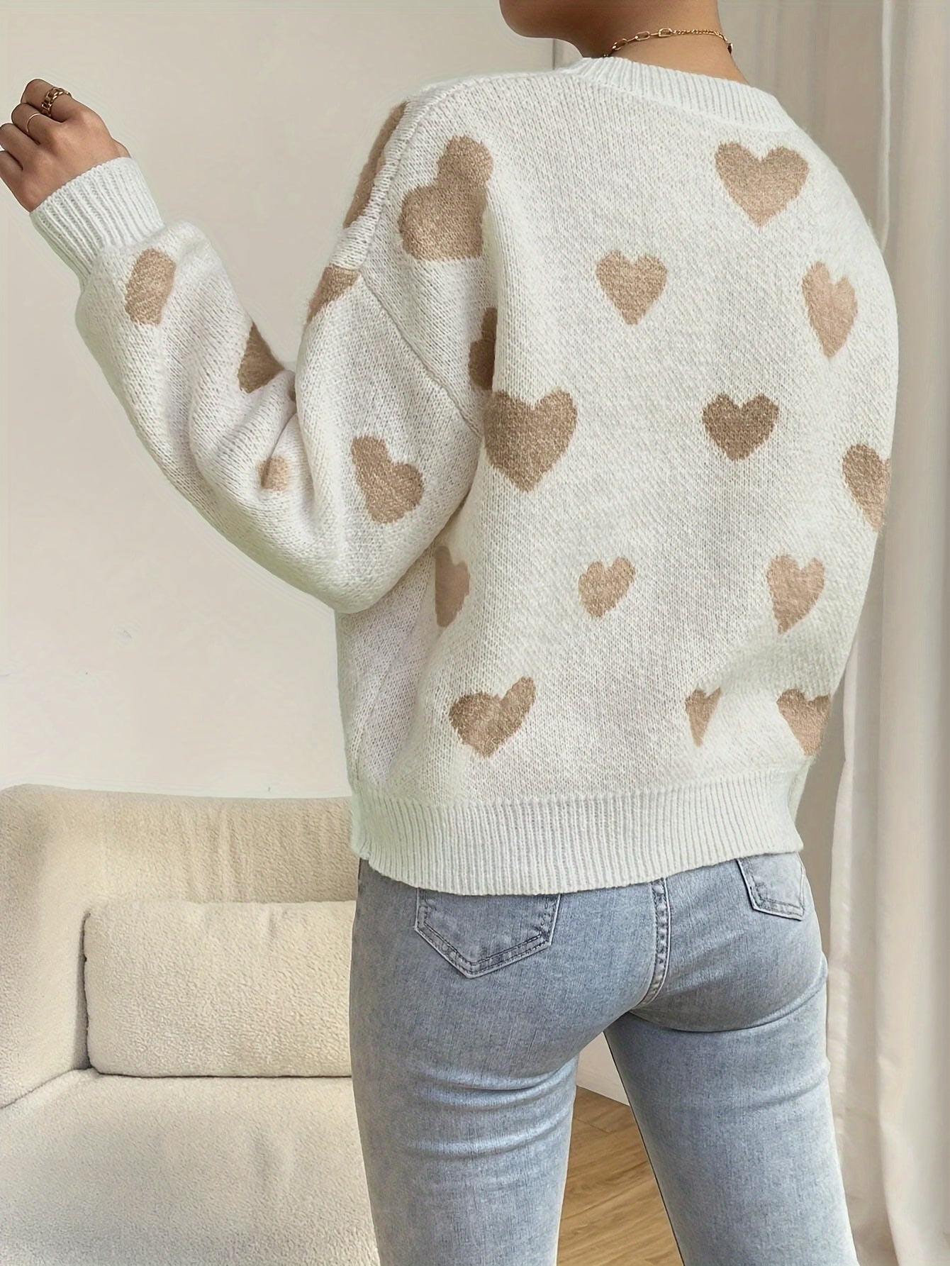 Women's cozy knit sweater in warm tones with playful heart design, soft stretchy fit for autumn winter