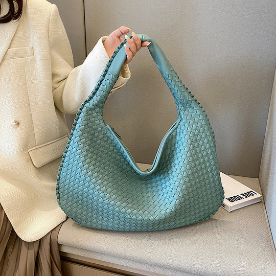 Braided eco-leather women's shoulder bag with textured woven detailing and sustainable finish