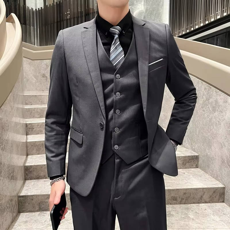 Men's slim fit three-piece suit in classic navy blue with matching vest, jacket, and tapered pants