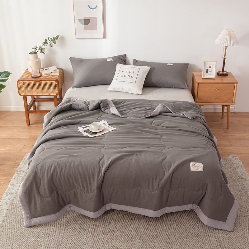 Minimalist white cotton quilt with stitched pattern, lightweight breathable design for hot sleepers