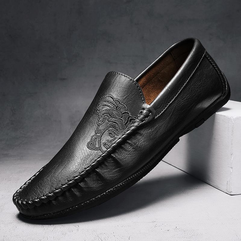 Men's brown full-grain leather loafers hand-stitched with signature embroidered motif, lightweight comfort