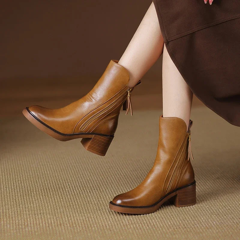 Women's black leather ankle boots with side zip tassel pull and stacked block heel for chic style