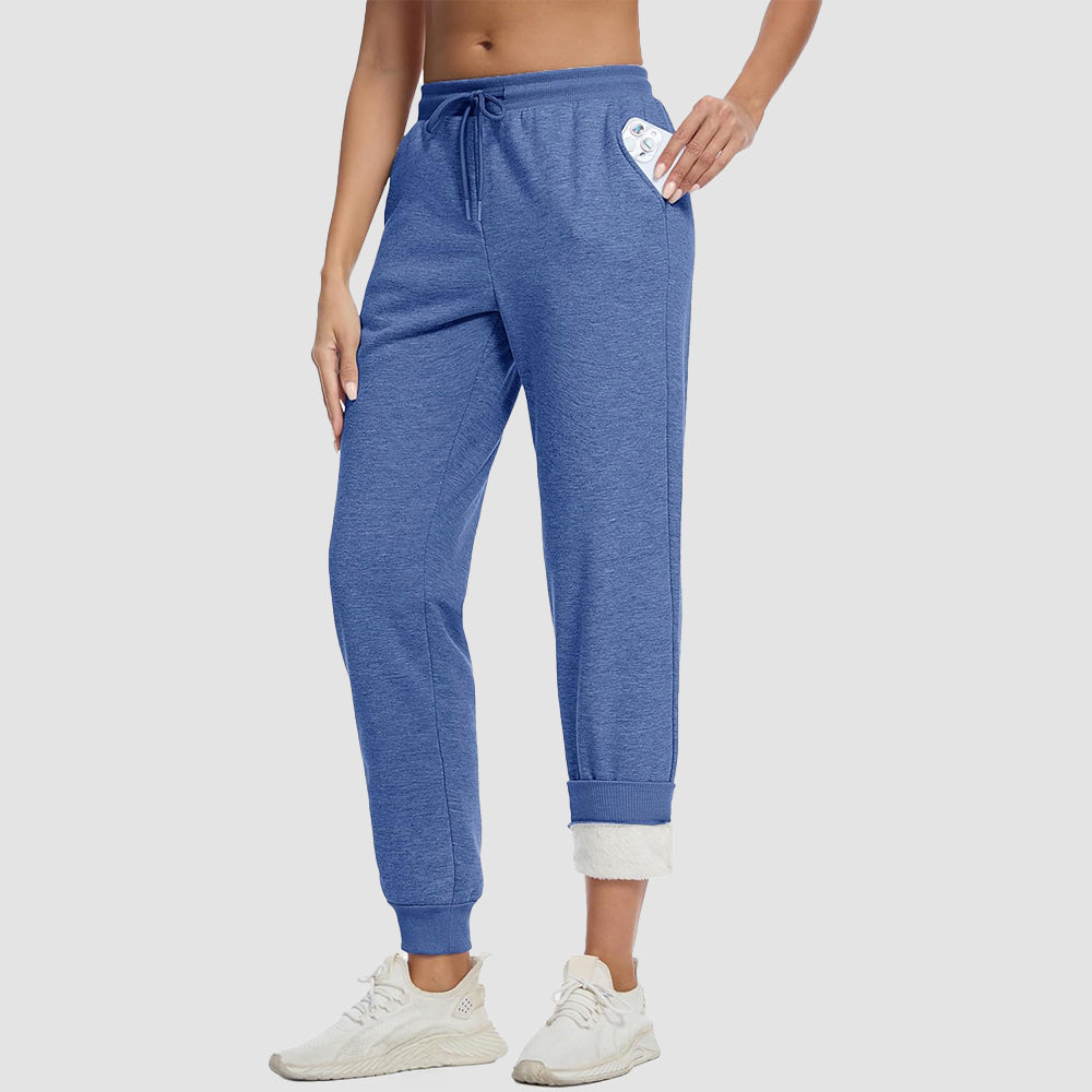 Women's sherpa lined fleece joggers in cozy winter style with deep side pockets