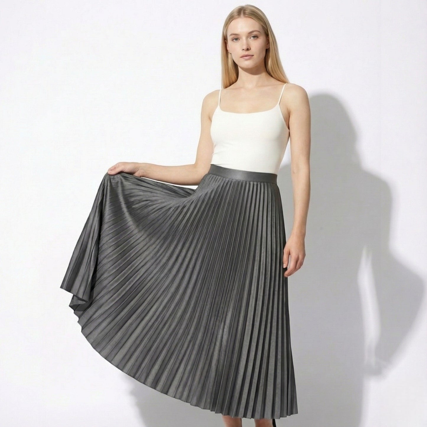 Women's high-waisted pleated satin skirt in neutral tone with graceful drape for office or casual wear